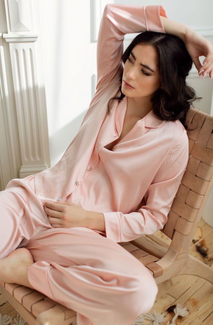 a model lounging in a silk luxury pj set in Canada from By Catalfo