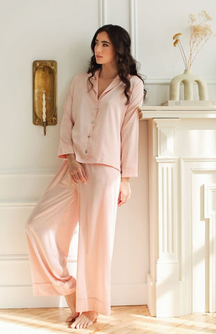 a women at home wearing luxury silk pajamas Toronto