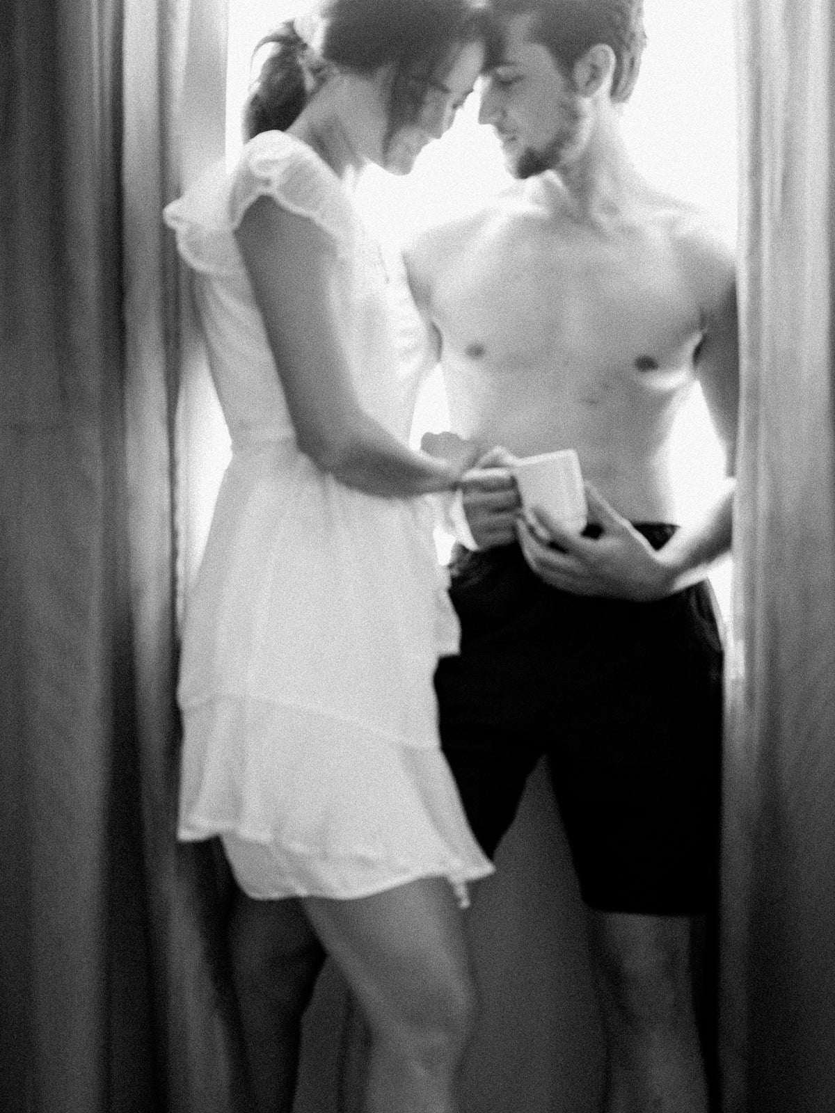 a couple gets ready together in a hotel room on their wedding morning