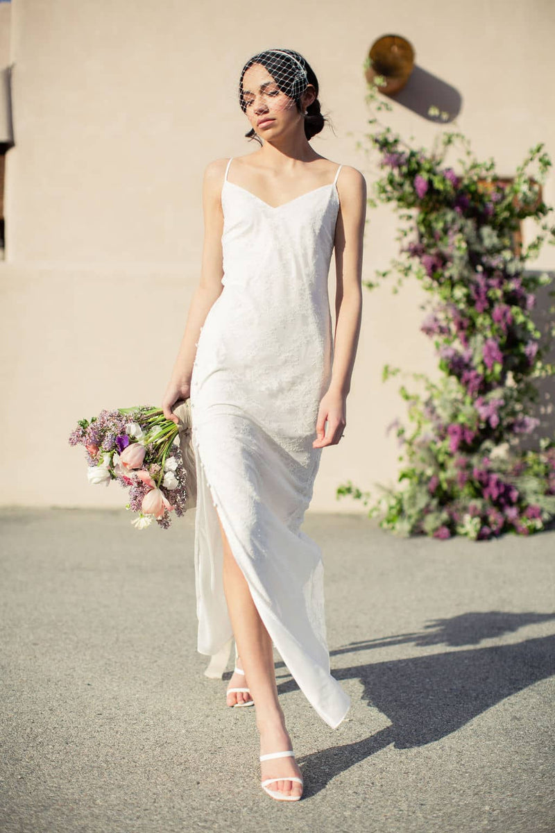 elegant and modern lace elopement dress with high skirt slit on a bride in the Okanagan, BC