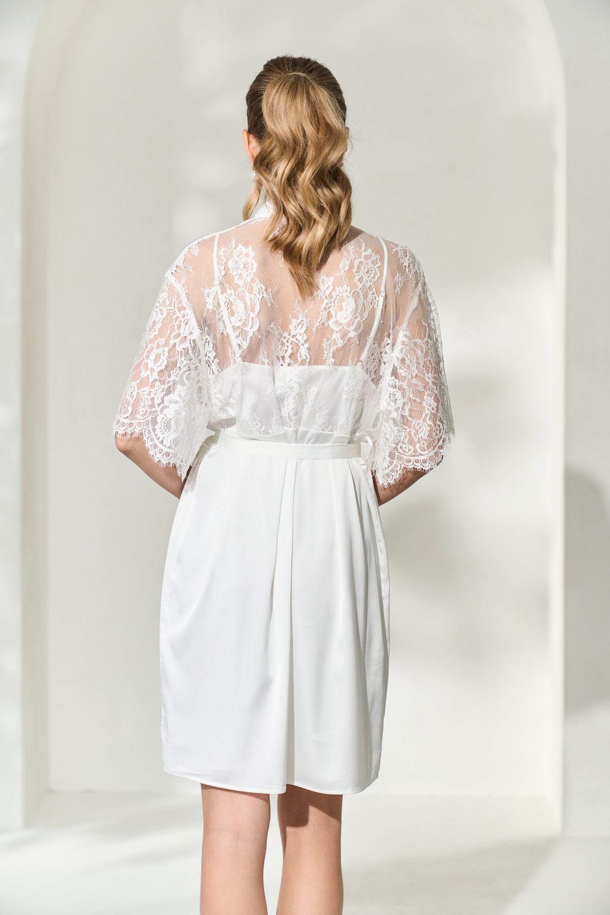 Back view of white bridal robe with lace back and lace sleeves