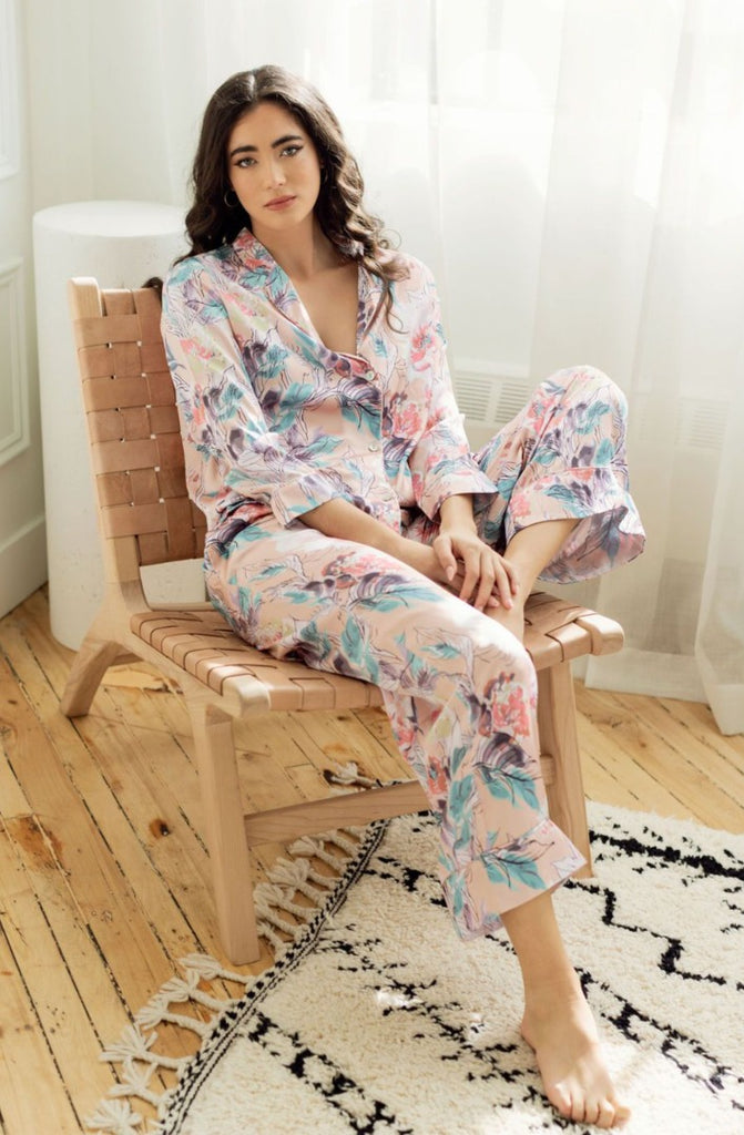 Woman lounging on chair wearing  silky floral print pajamas