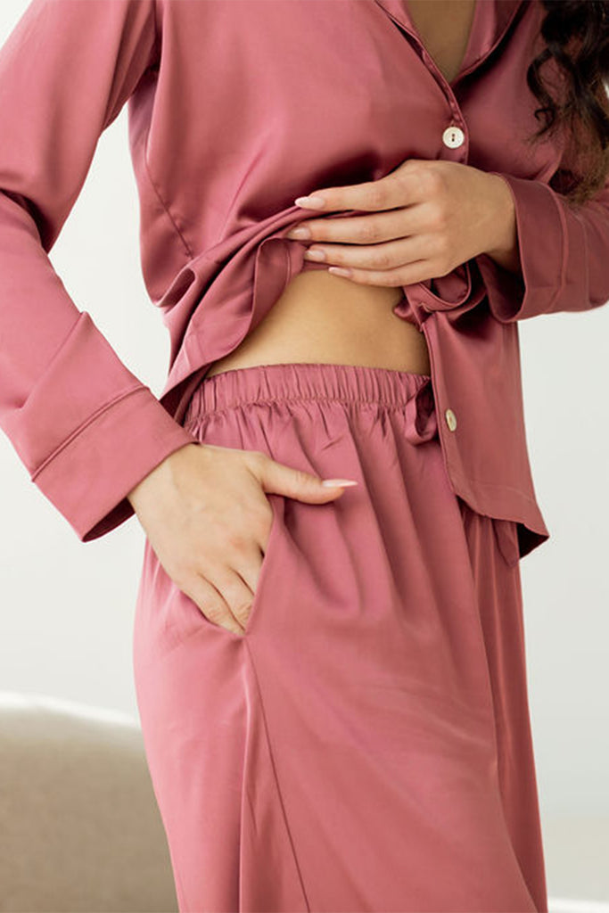 Close up view showing elastic waistband of woman's red pajama pants