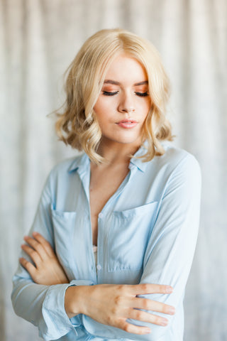 Close up view of light blue boyfriend shirt with collar. 