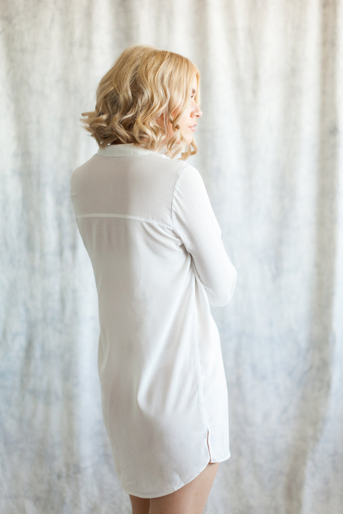 Back view of woman wearing white boyfriend shirt