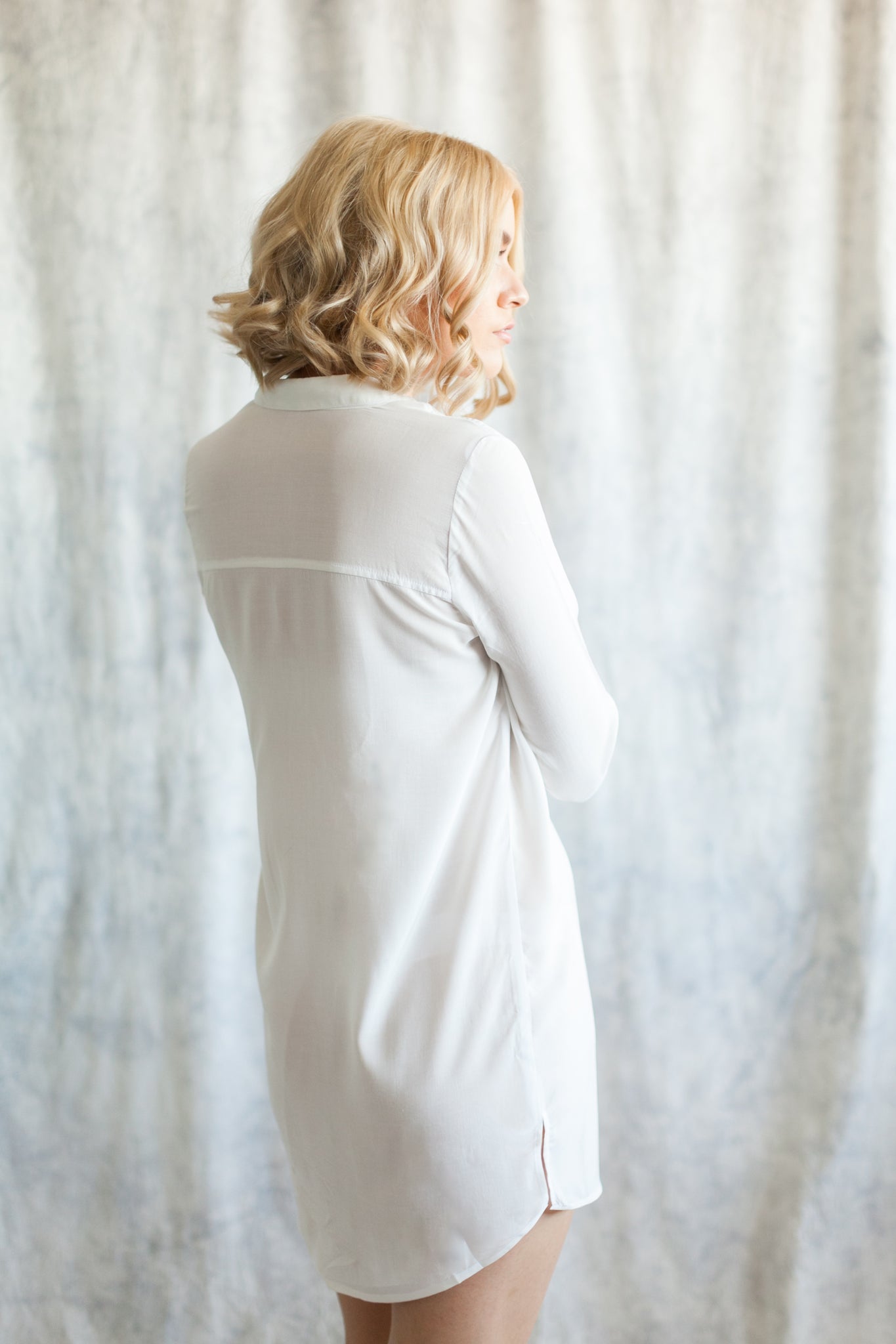 Back view of woman wearing white boyfriend shirt