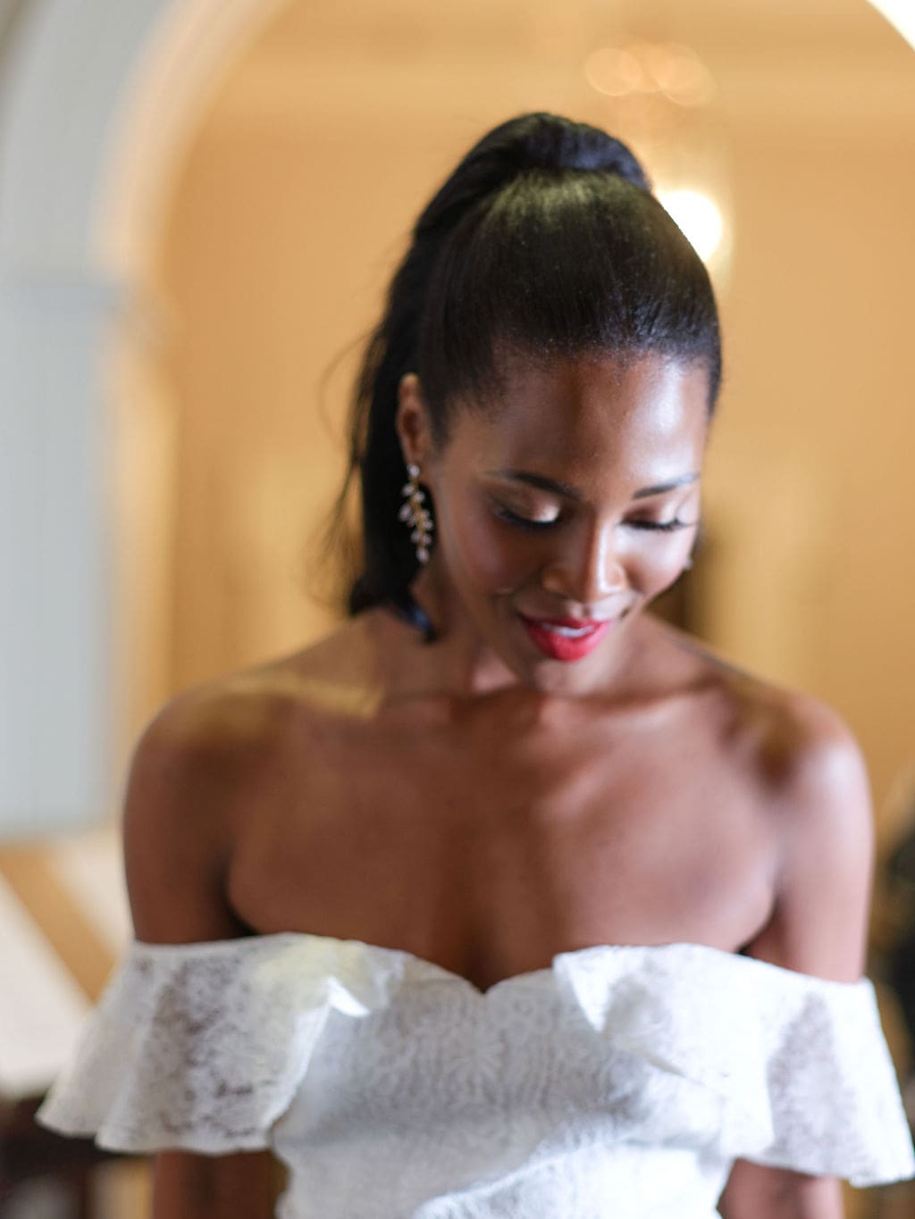 Woman smiling wearing a strapless bridal jumpsuit