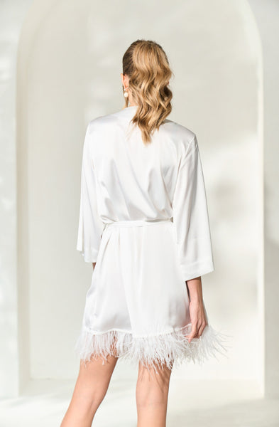 a back view of By Catalfo's luxury, silky white feather wedding robe for brides