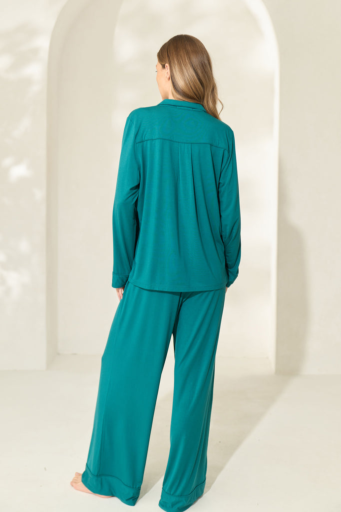 Back view of woman wearing juniper green modal pajama set with long sleeves.