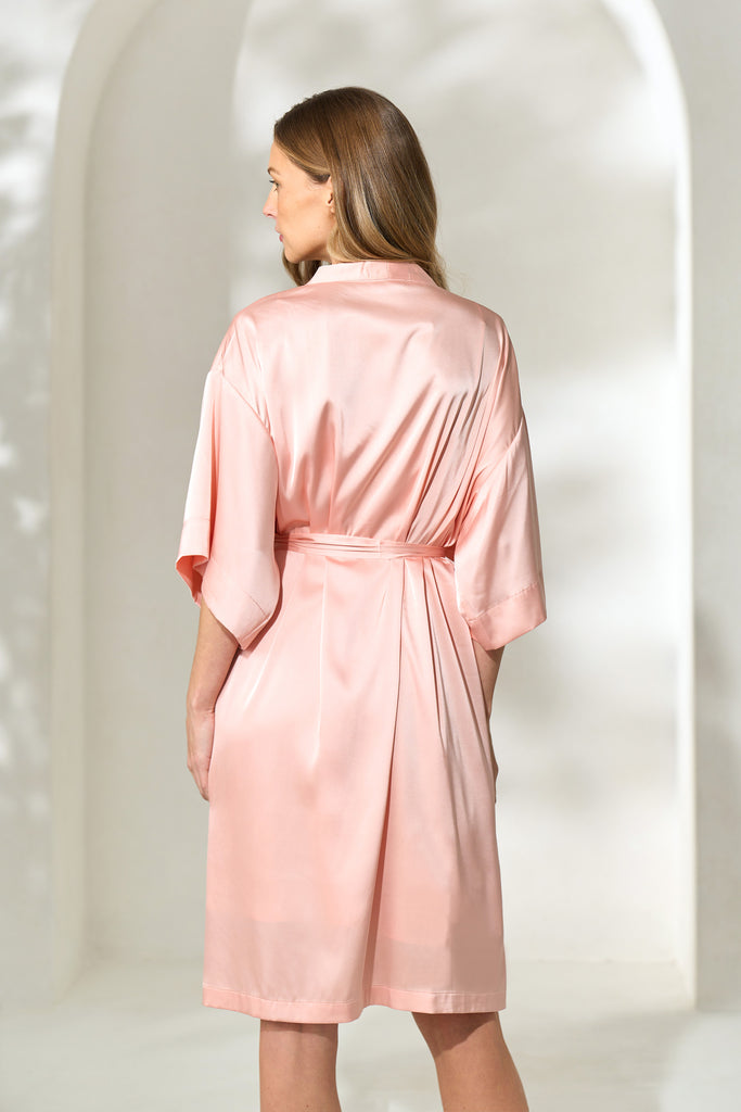 Pink Robe Back View Back view of woman wearing silky knee-length blush pink robe with waist ...