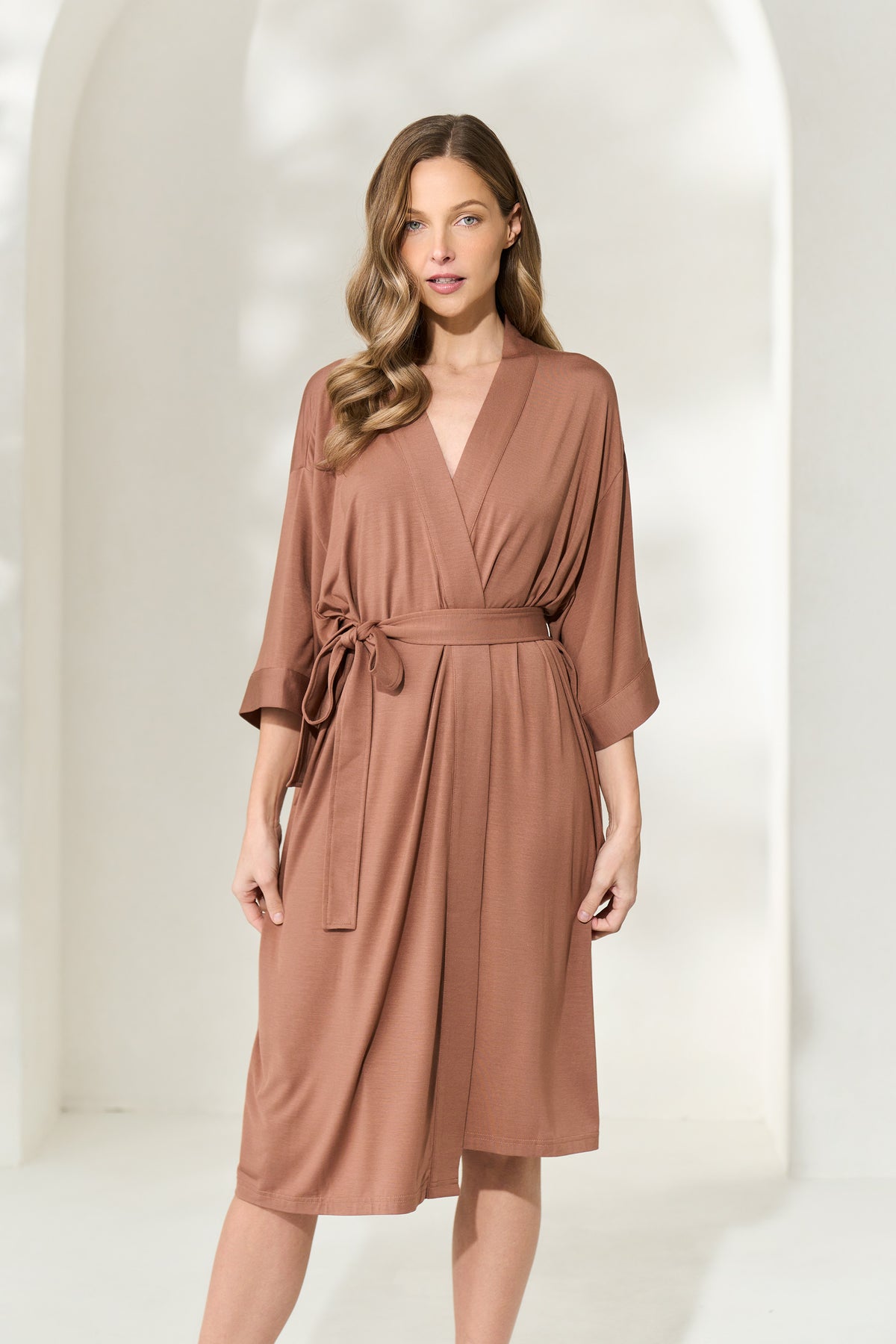 Woman wearing brown knee-length modal robe with waist tie