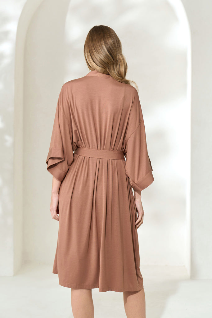 Back view of woman wearing brown knee-length modal robe with waist tie