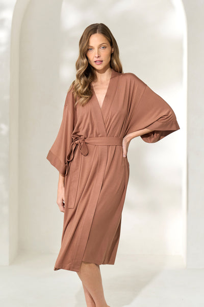 Woman posing with hand on waist wearing brown knee-length modal robe with waist tie