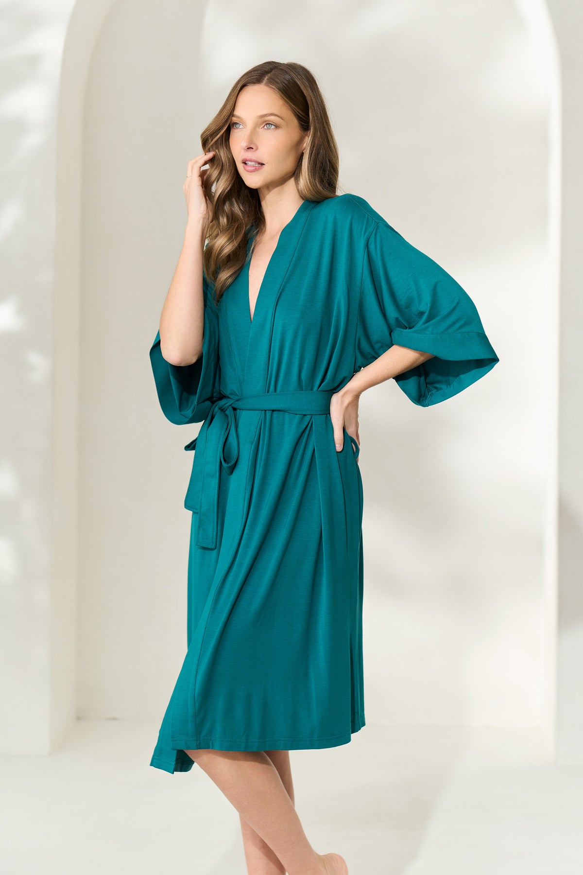 Woman wearing juniper green knee-length modal robe with waist tie