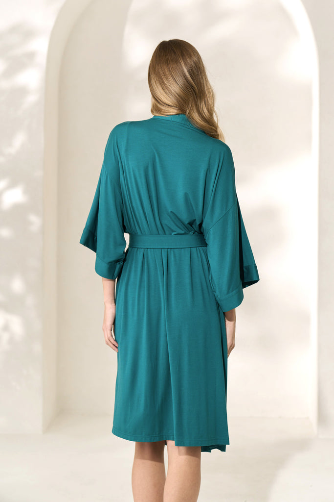 Back view of woman wearing knee-length juniper green modal robe