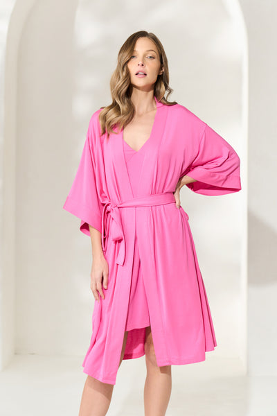 Woman wearing sorbet pink knee-length modal robe with waist tie