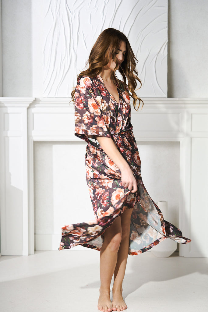 a women twirling in a silk floral robe for luxury travel destinations