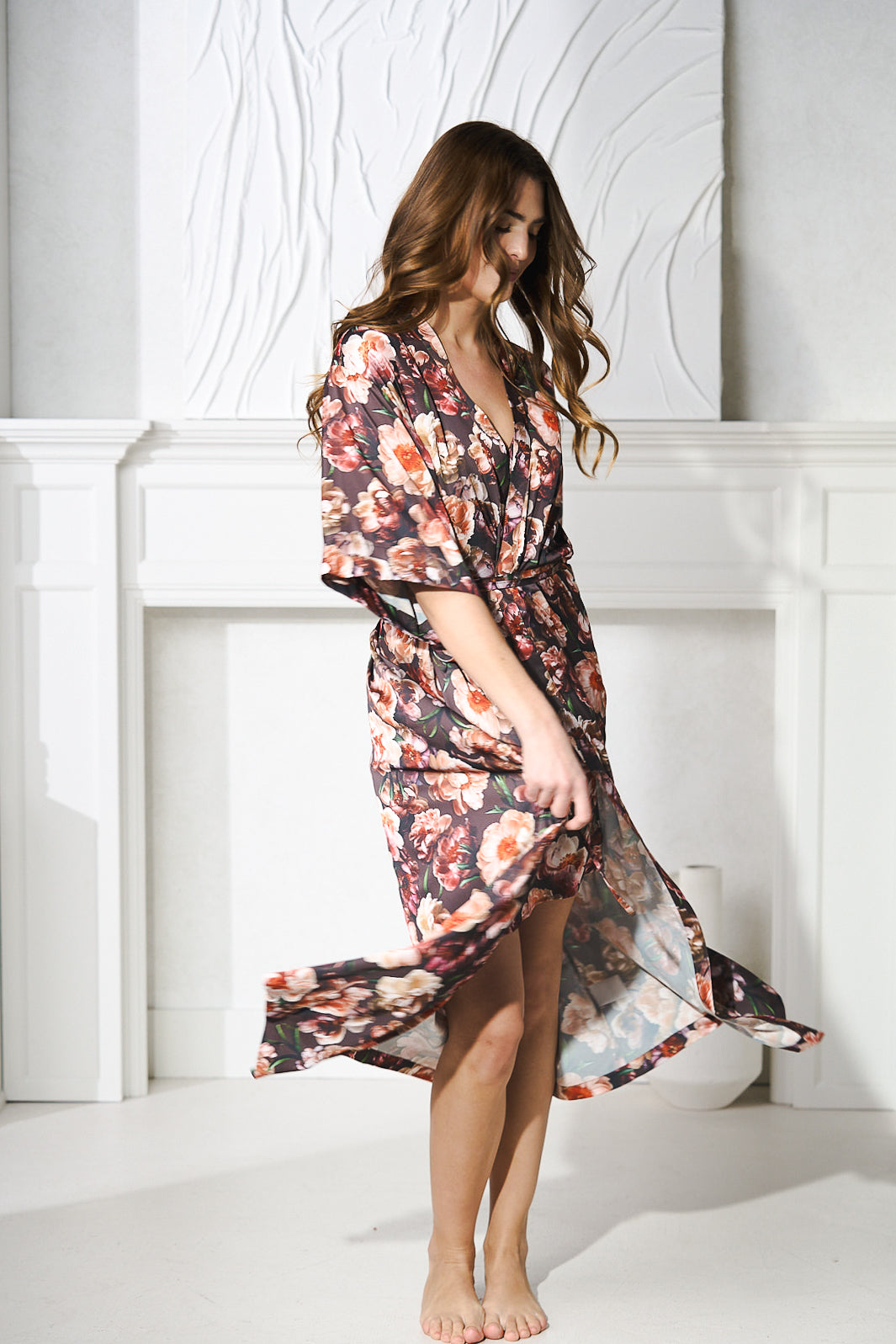 Comfy Luxe Robe a women twirling in a silk floral robe for luxury travel destinations