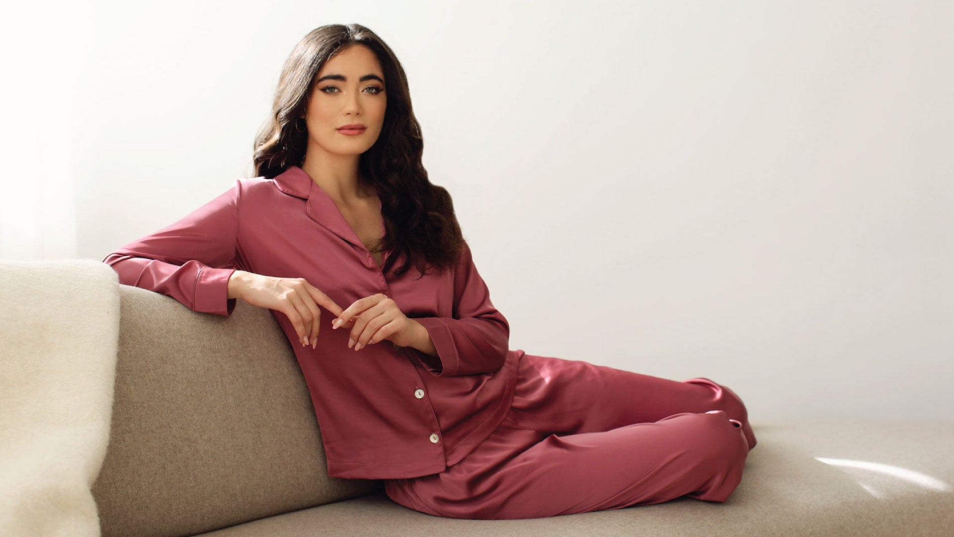a woman lounges wearing Canadian women silk pajamas