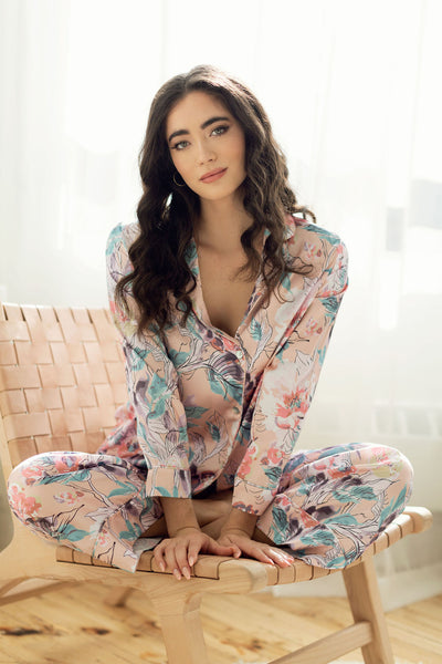 a model lounges in silky floral pyjamas on modern accent chair in Toronto