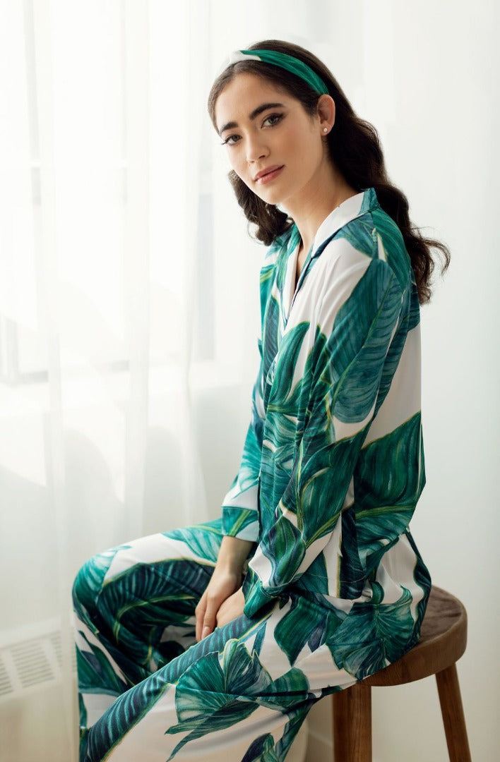 A Toronto women wearing a silky pyjama set in luxury palm print for gifting and loungin in.