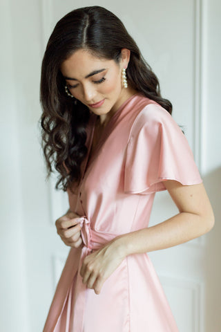 a models ties her bridesmaid wrap dress 