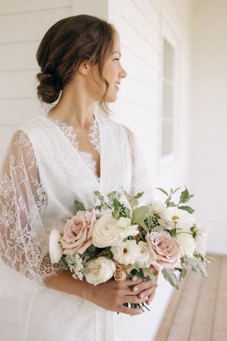 a muskoka bride on her wedding morning wearing a white lace robe