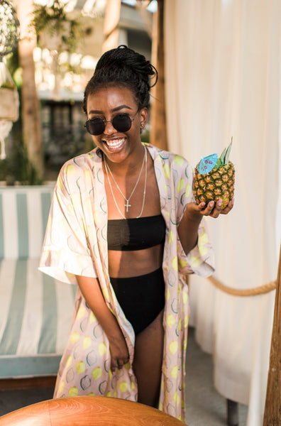 a model wears tropical poolside attire in lemon print