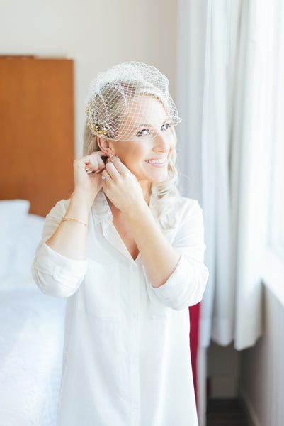 a bride wearing by catalfo boyfriend while getting ready on her wedding day