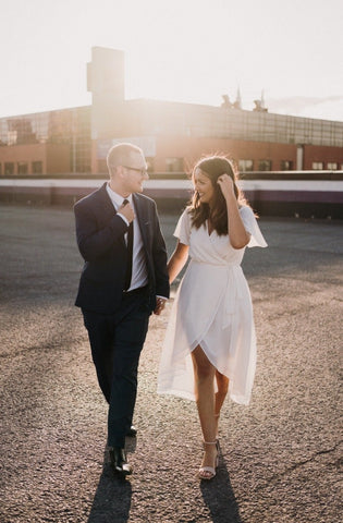 a bride wears white midi length wrap dress for canadian elopement ceremony