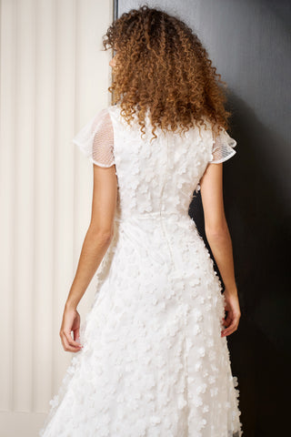 back view of By Catalfo midi length white 3D floral party dress